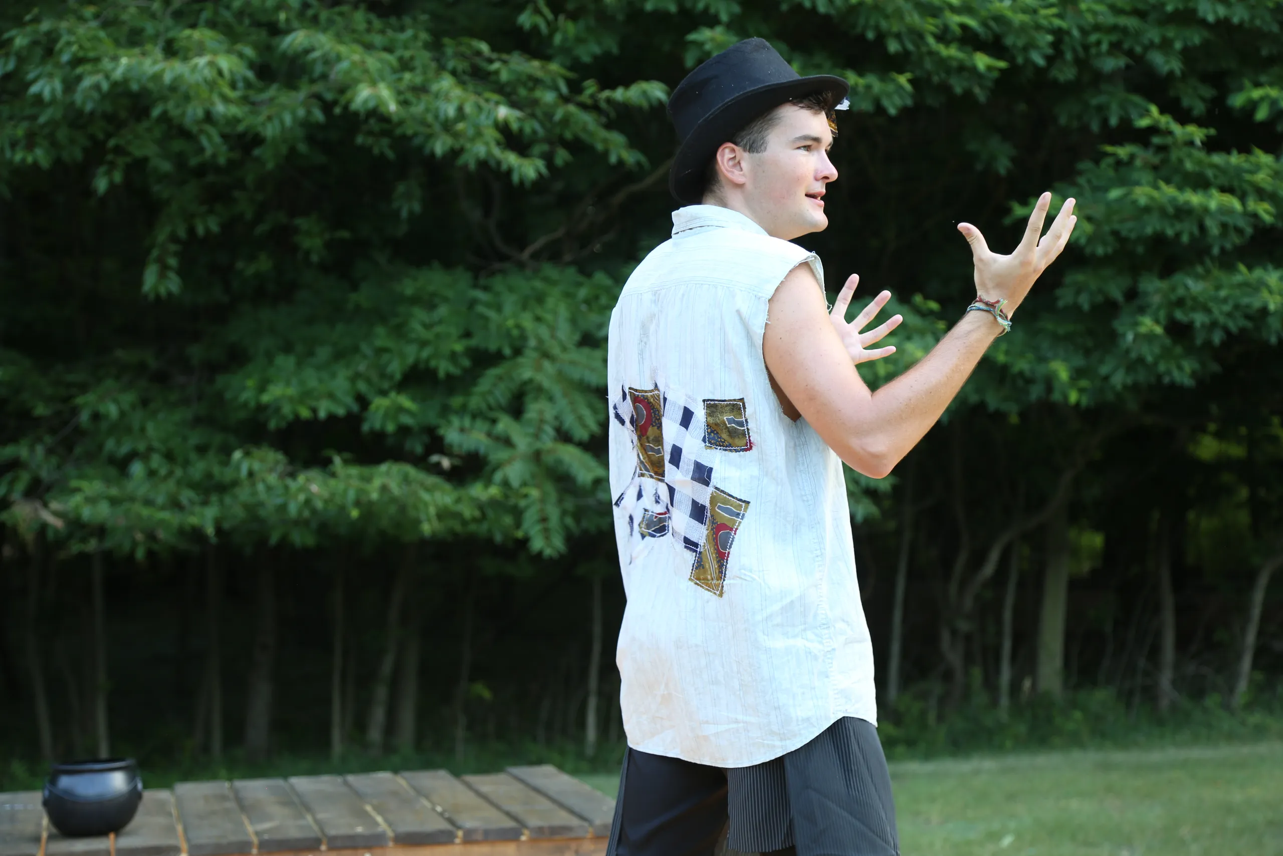 A performer in costume acting on the outdoor stage