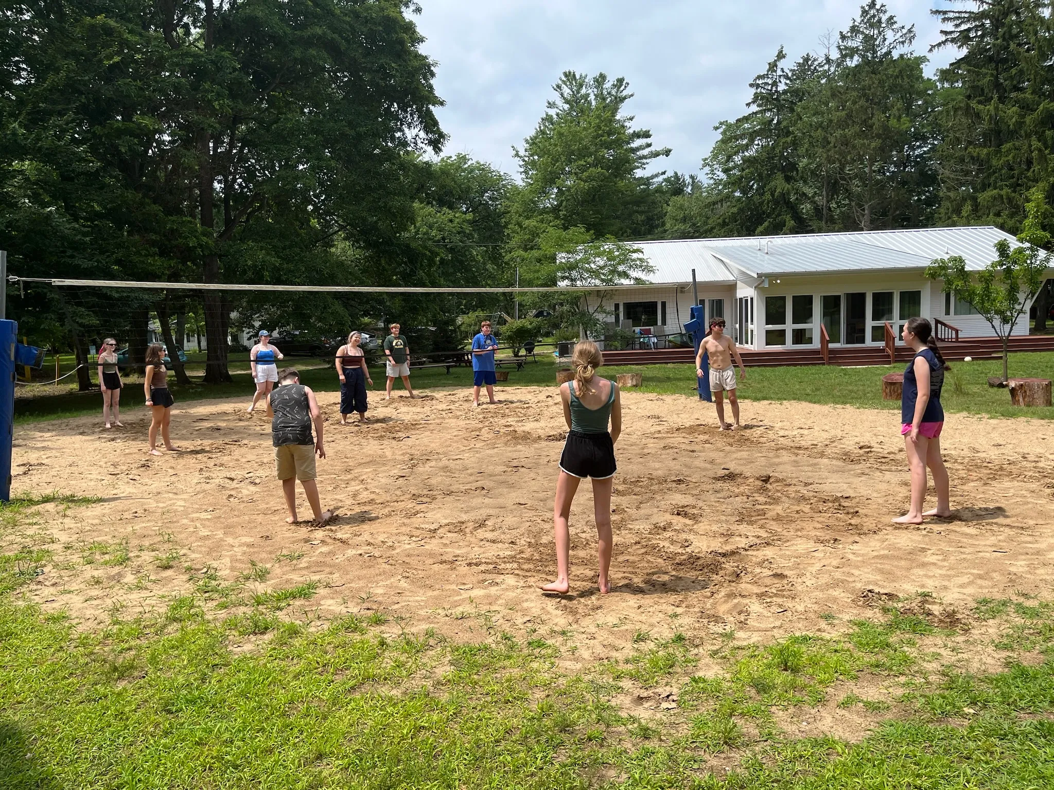 Campers playing sand volleyball on the camp court