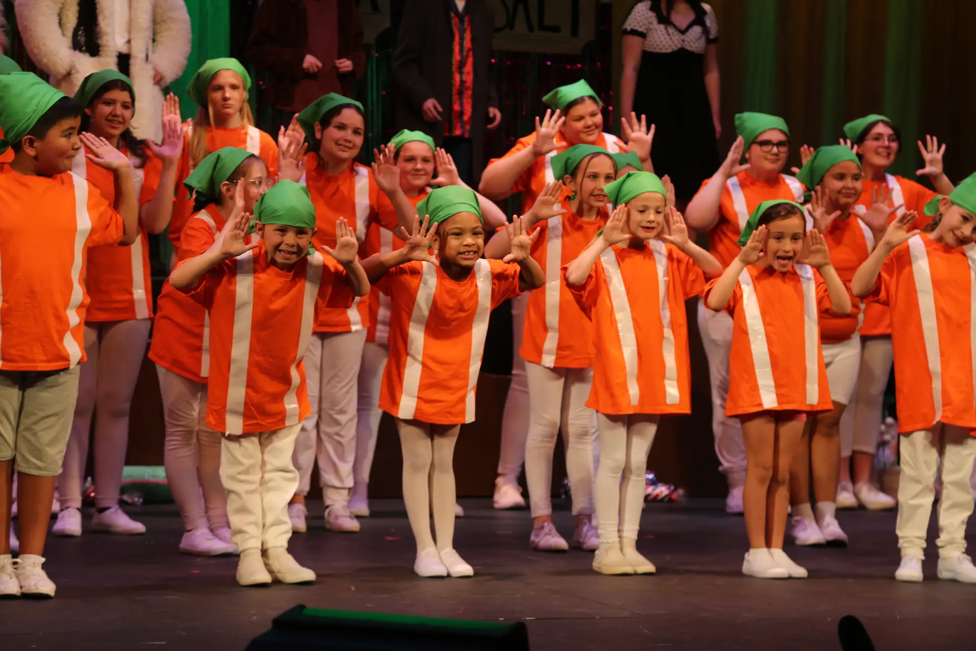 Oompa Loompas performing on stage in Charlie and the Chocolate Factory Jr.